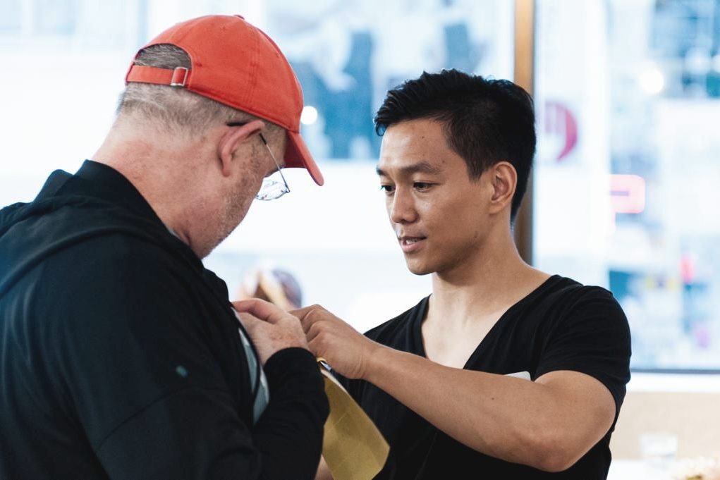Paul Kam coaching a participant one-to-one during a communications workshop